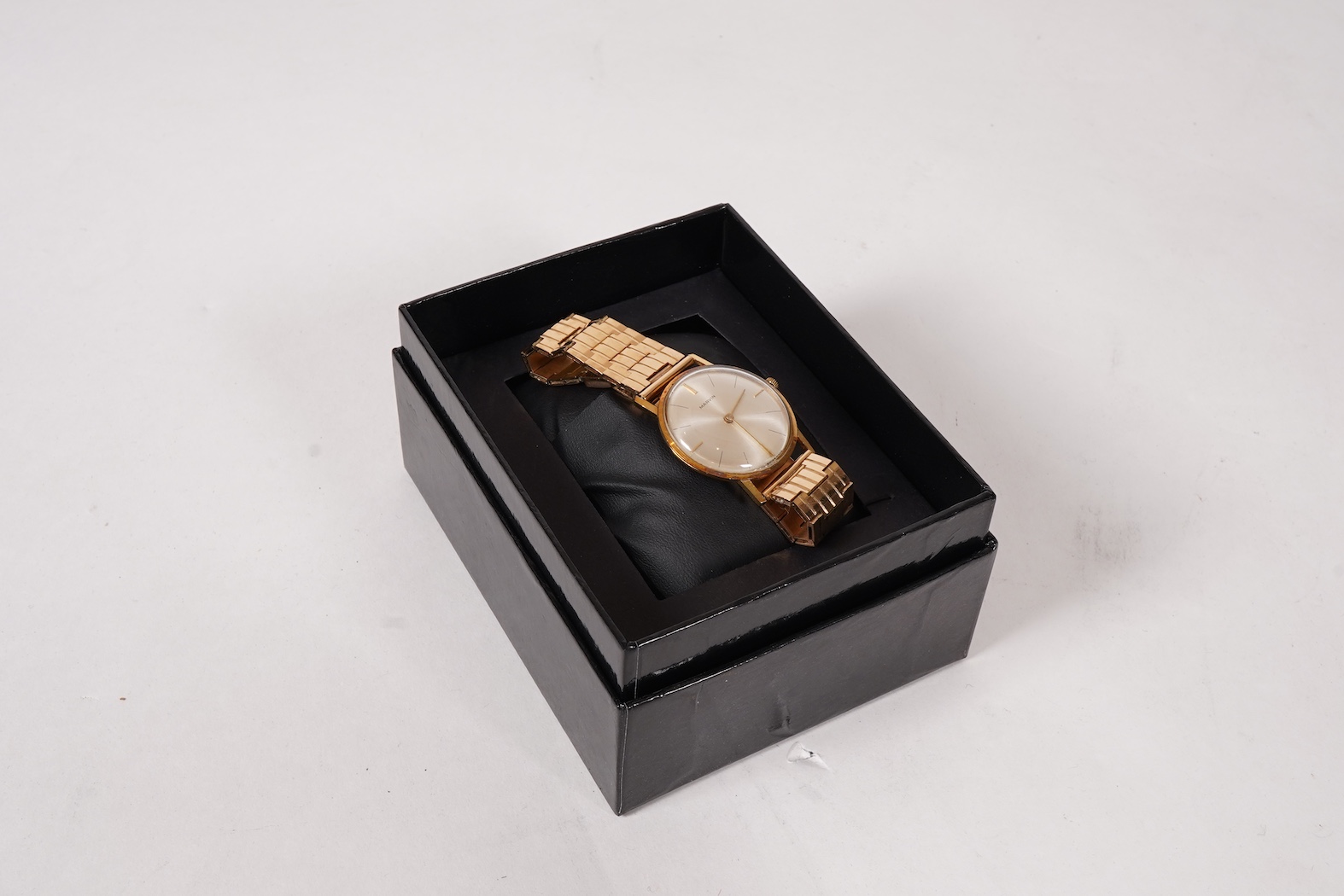 A gentleman's Swiss 18k gold Marvin manual wind dress wrist watch, with a Swiss 18k gold fancy brick link bracelet